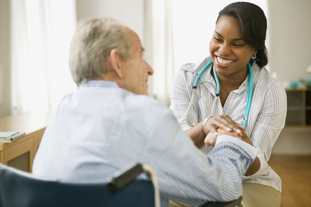 Nurse and elderly man spending time together --- Image by © Jose Luis Pelaez, Inc./Blend Images/Corbis